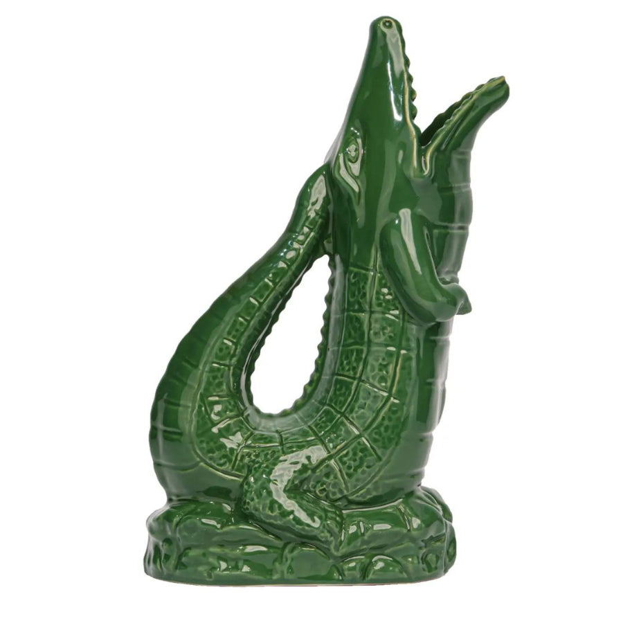 Green crocodile figurine on a white background
