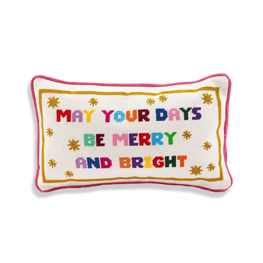 Decorative pillow with colorful Christmas text on a white background