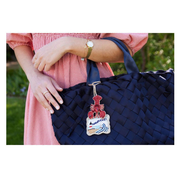 Navy blue woven handbag with Bag charm with a lobster and Nantucket lighthouse design 