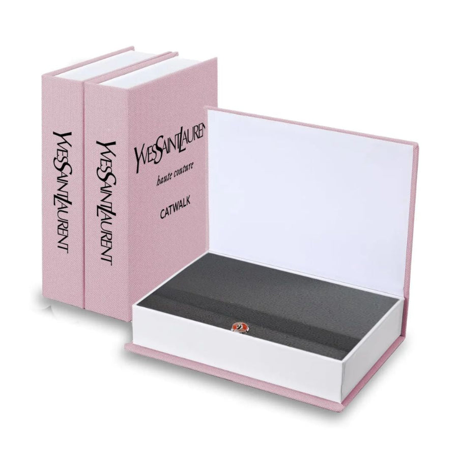Pink Yves Saint Laurent book-shaped box with a white interior