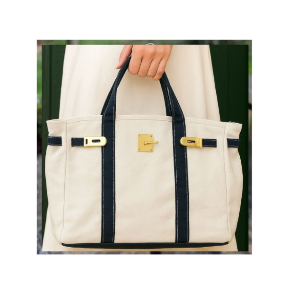 White tote bag with navy straps and gold hardware 