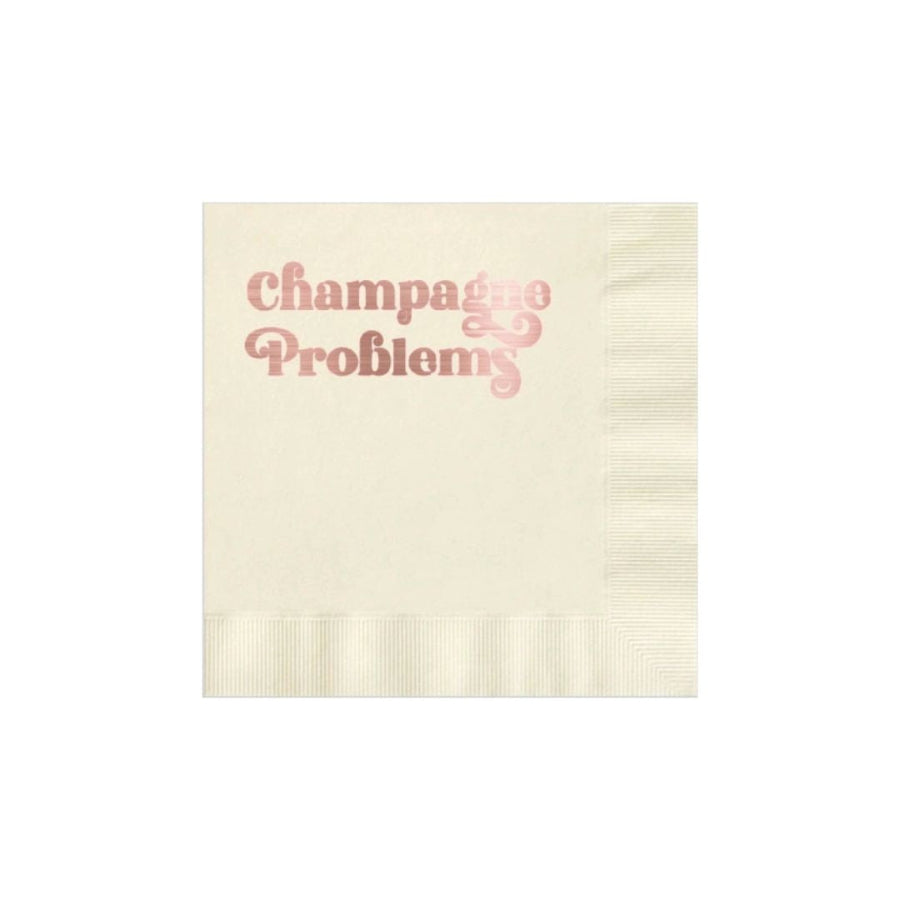 Beige towel with 'Champagne Problems' text in pink on a white background