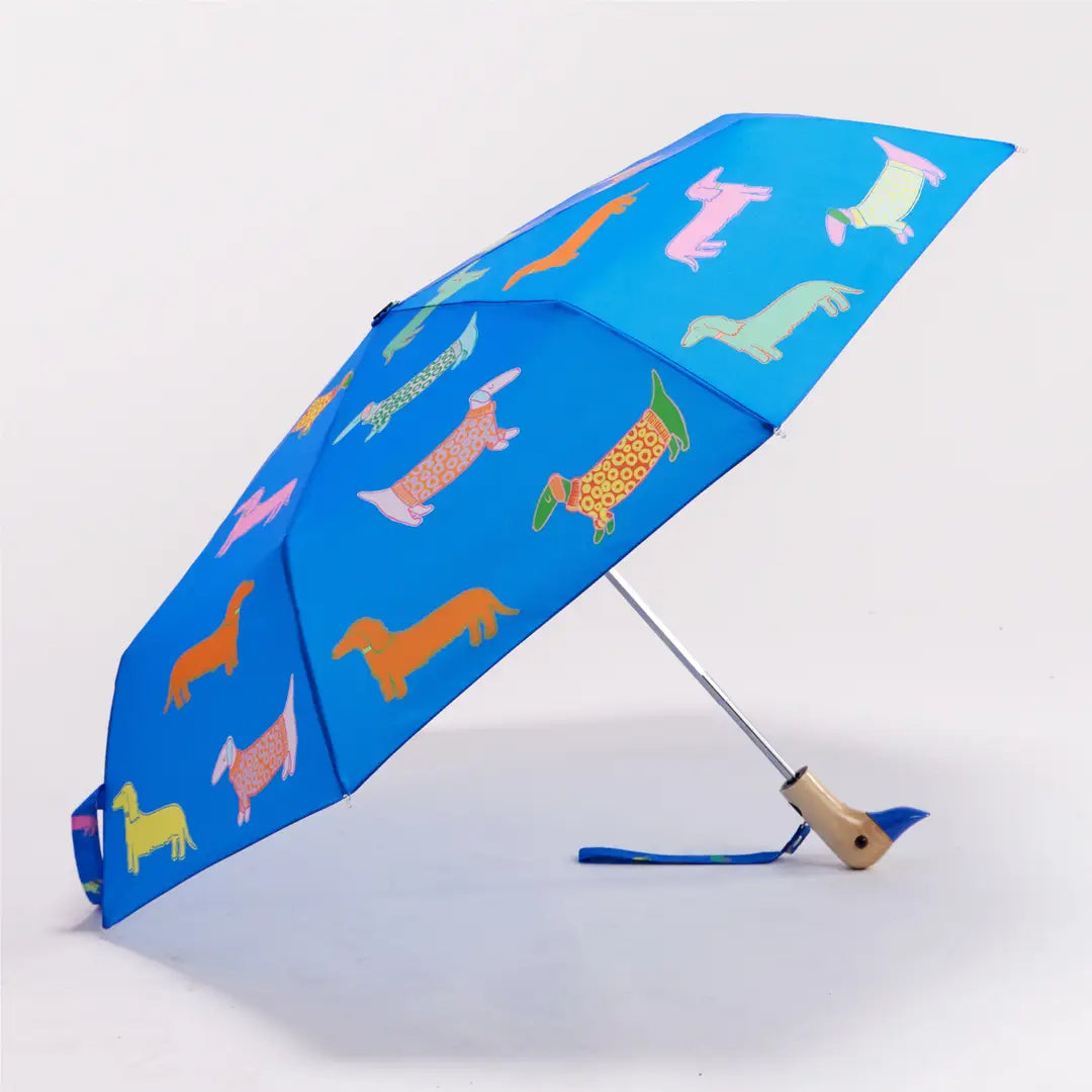 Blue umbrella with colorful dog pattern on a white background