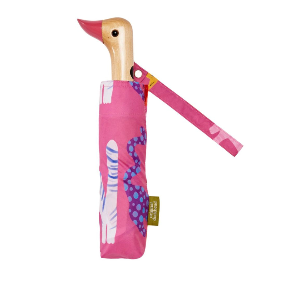Pink umbrella with duck-shaped handle with cats