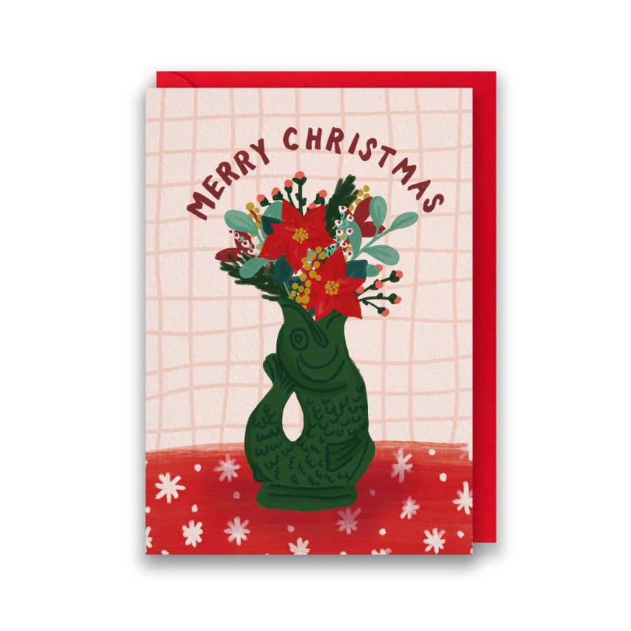 Christmas card with a green gluggle jug holding flowers and 'Merry Christmas' text on a red border.