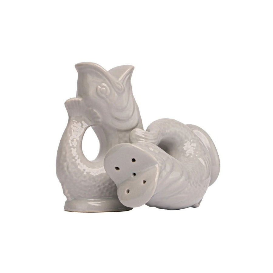 A pair of ceramic salt and pepper shakers shaped like stylized fish, in a glossy off-white finish, set against a plain white background.
