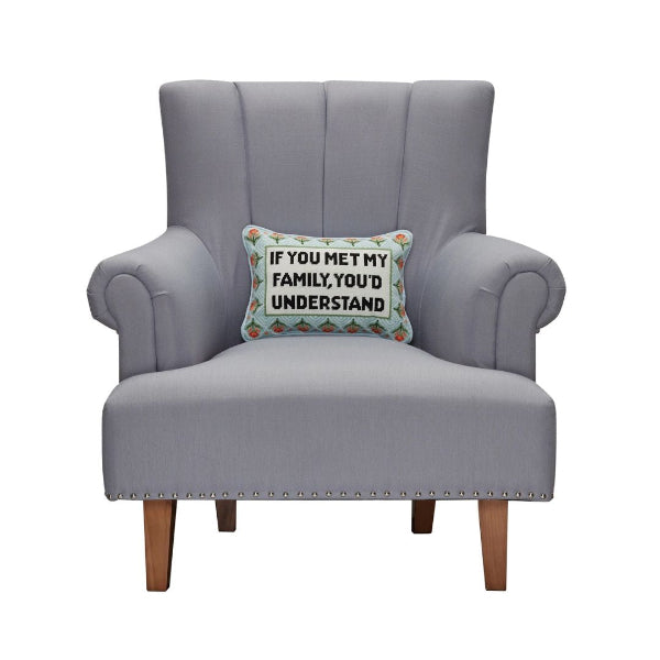 Gray armchair with a decorative pillow on a white background