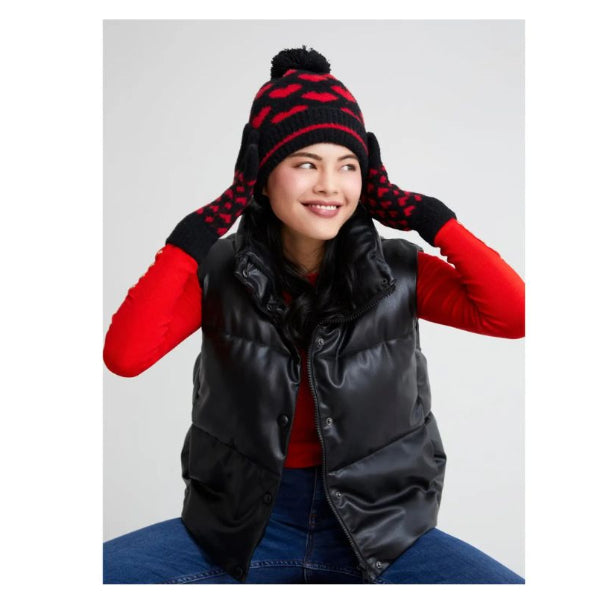Person wearing a black puffer vest, red shirt, and patterned beanie on a white background