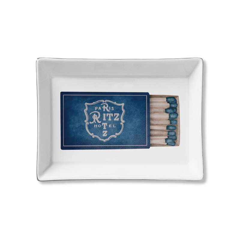Rectangular white dish with Paris Ritz Hotel matches on a white background