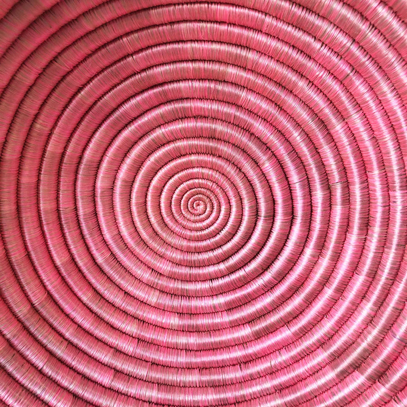 pink african woven bowl close up 