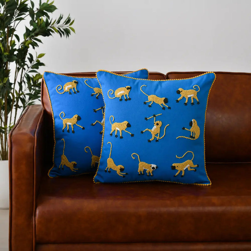 embroidered monkeys throw pillows on couch